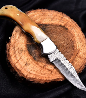 Deer Edge handcrafted folding Damascus knife with detailed handle and sheath