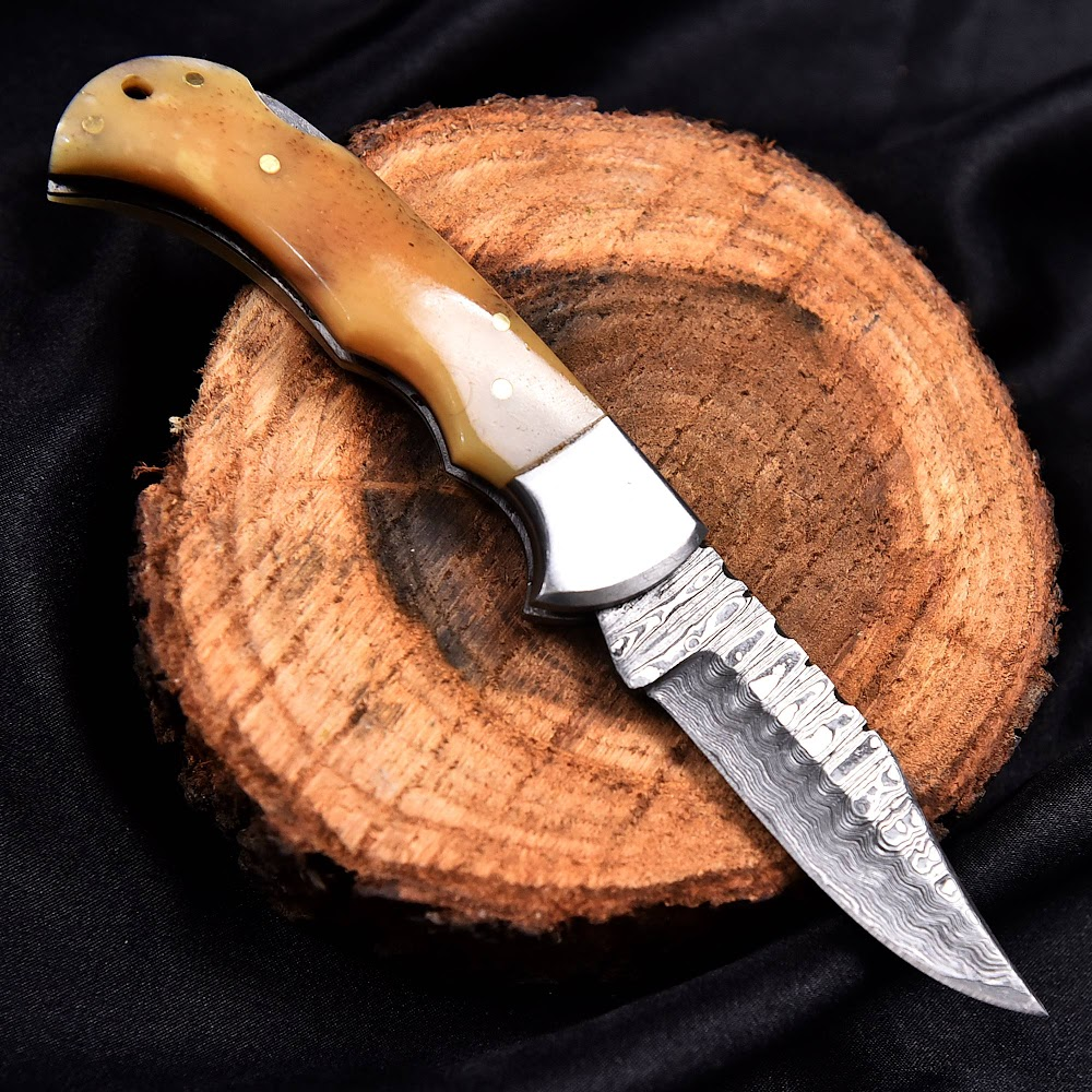 Deer Edge handcrafted folding Damascus knife with detailed handle and sheath