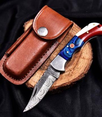 Handcrafted Damascus folding knife with detailed handle and leather sheath from Deer Edge