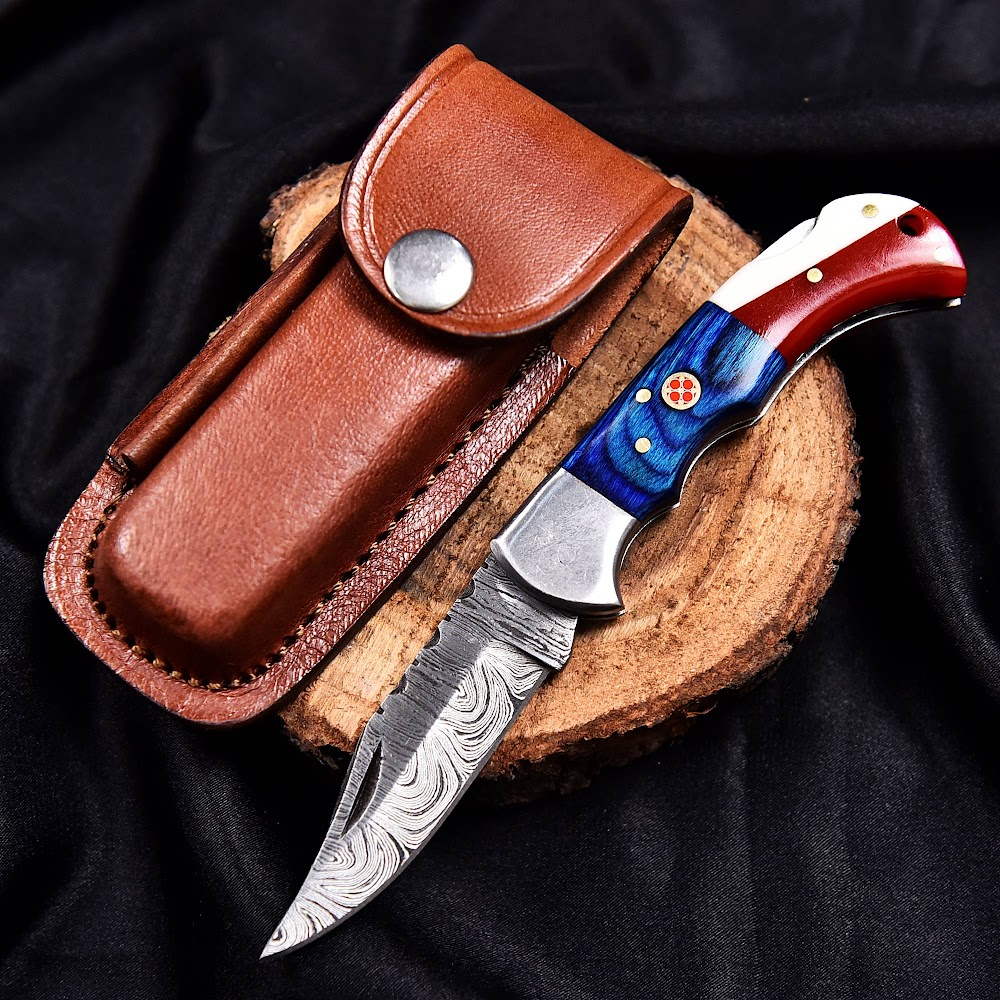 Handcrafted Damascus folding knife with detailed handle and leather sheath from Deer Edge